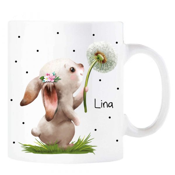 Auf dem Bild ist das Produkt: Tasse aus Keramik Hase mit Pusteblume – Wunschname zum Preis von €16.90 abgebildet.