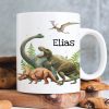 Auf dem Bild ist das Produkt: Kindertasse Tasse Dinosaurier personalisiert Wunschname zum Preis von €18.9 abgebildet.