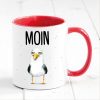 Auf dem Bild ist das Produkt: Bedruckte Keramiktasse Geschenkidee maritime Tasse Moin mit Möwe Geburtstagsgeschenk zum Preis von €17.9 abgebildet.