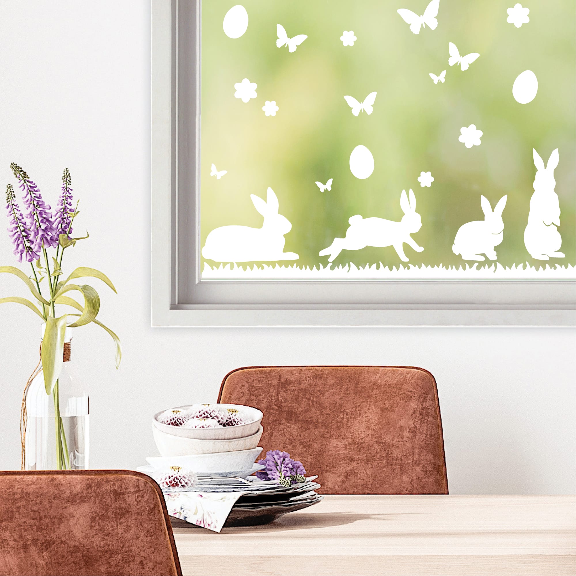 Auf dem Bild ist das Produkt: Fensteraufkleber Hasen mit Ostereiern und Schmetterlingen WIEDERVERWENDBAR zum Preis von €12.90 abgebildet.